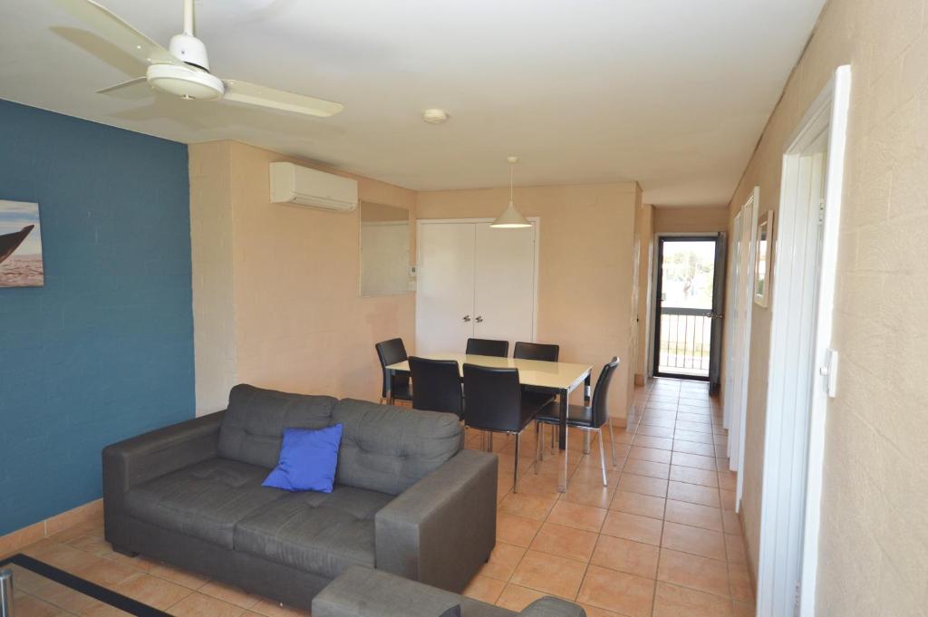 ein Wohnzimmer mit Sofa und Tisch in der Unterkunft Riverview Holiday Apartment 65 - Kalbarri WA in Kalbarri