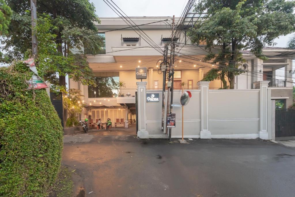 a building with a gate in front of a street at Urbanview Darmo Residence Bandung in Bandung