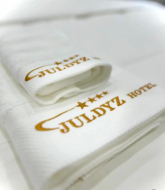 a white towel with the words sunday hotel on it at Juldyz in Zharkent