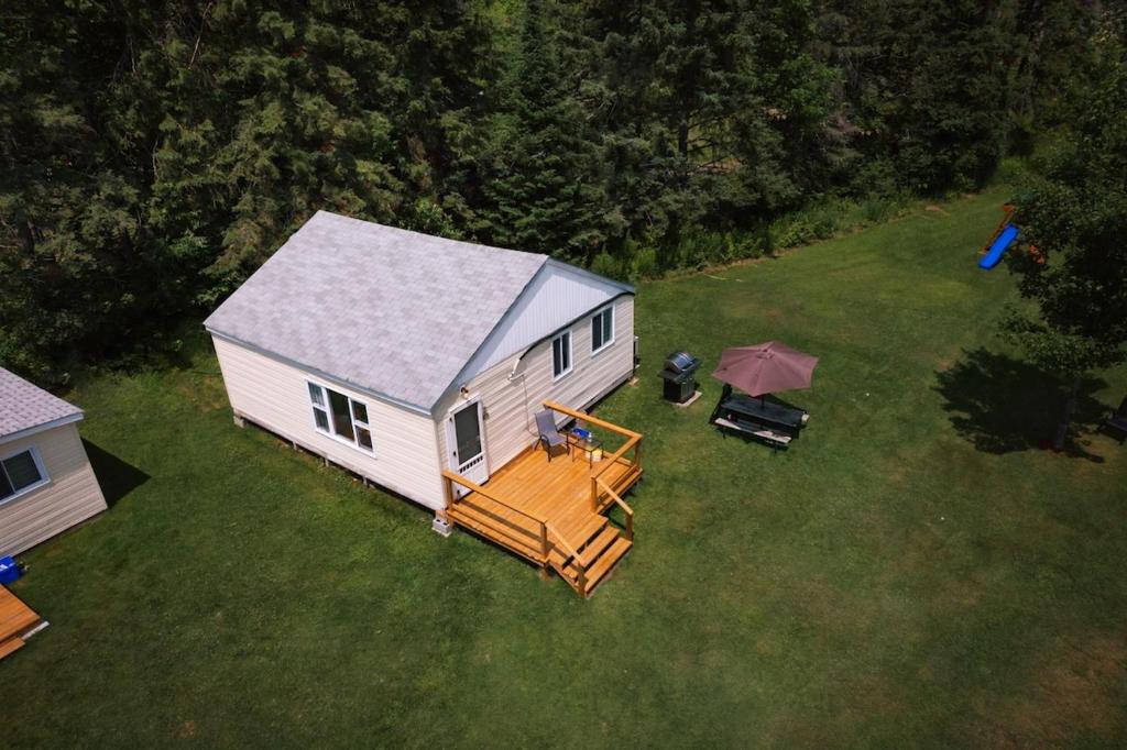 een luchtzicht op een wit huis met een terras bij Beachfront Cottage #2- Maijac Resort & Marina in Burks Falls