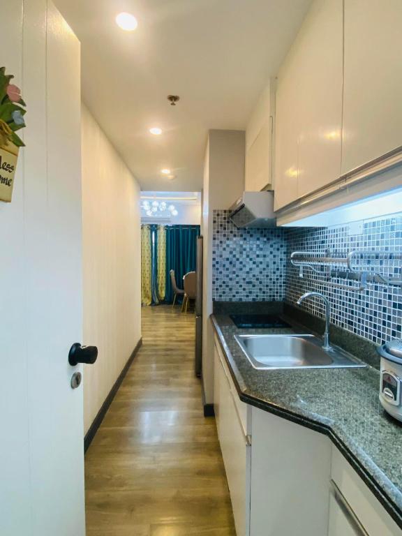 a kitchen with a sink and a counter top at Torre de Manila 1BR in Manila