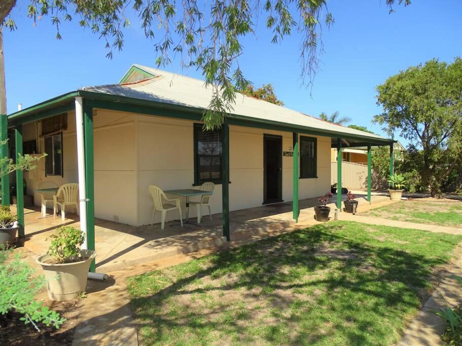 a small house with a table in a yard at Sun on the Stubble in Maitland