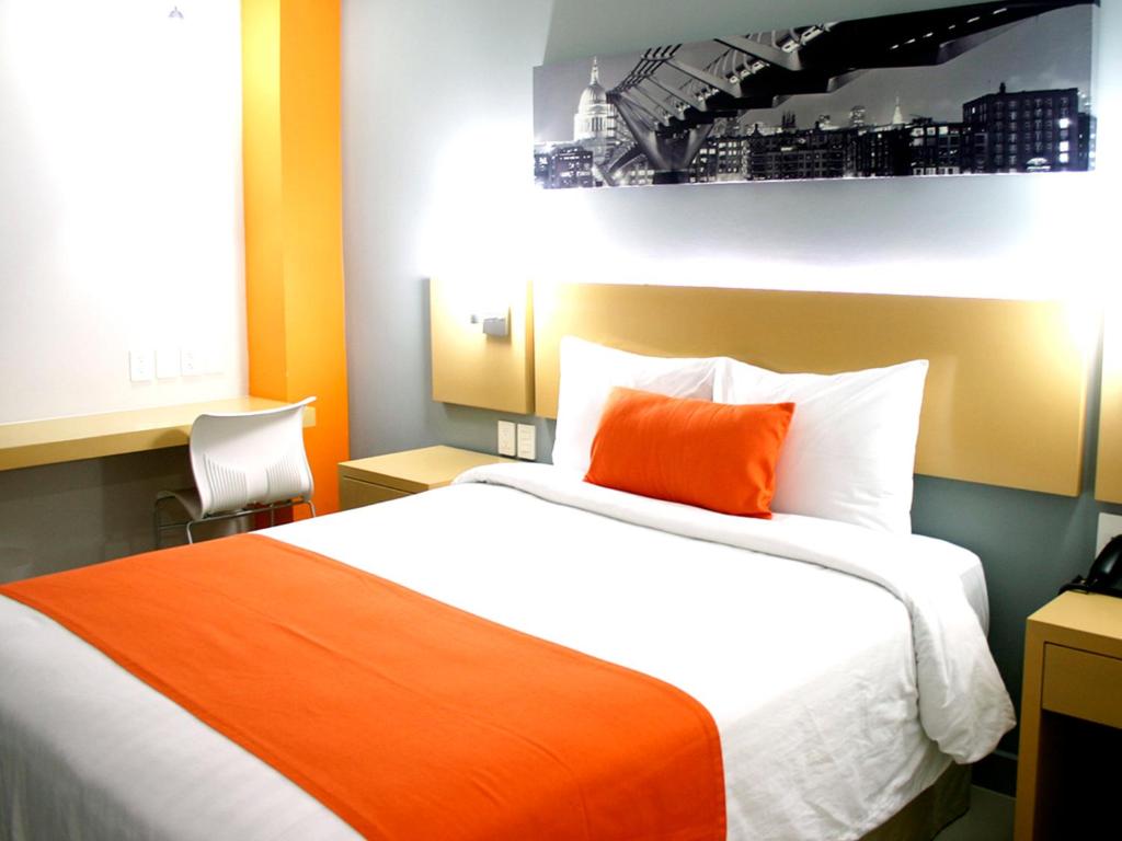 Postel nebo postele na pokoji v ubytování Hotel Urbainn