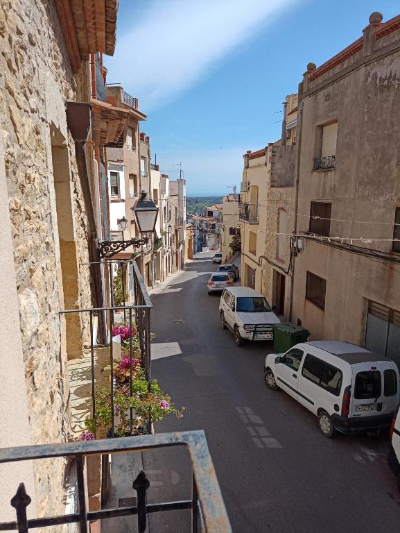 a city street with cars parked on the side of a building at Tranquil and Spacious Townhouse in Historical and Picturesque Cervera Del Maestre in Cervera del Maestre
