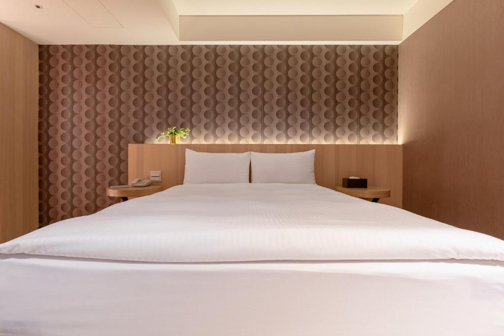 Postel nebo postele na pokoji v ubytování Guide Hotel Taipei Fuxing North