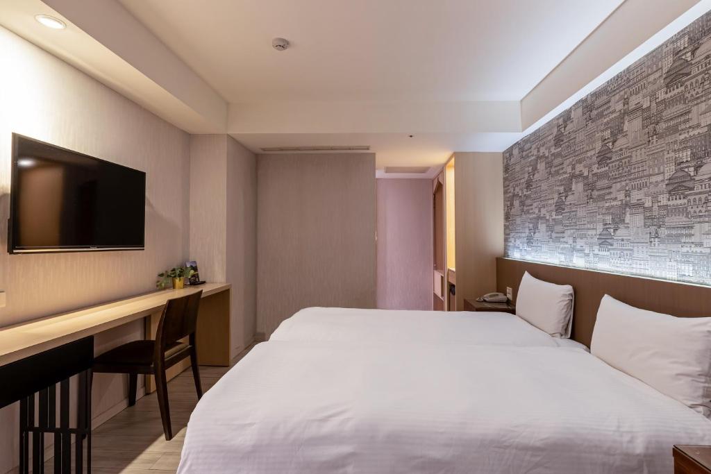 Postel nebo postele na pokoji v ubytování Guide Hotel Taipei Fuxing North