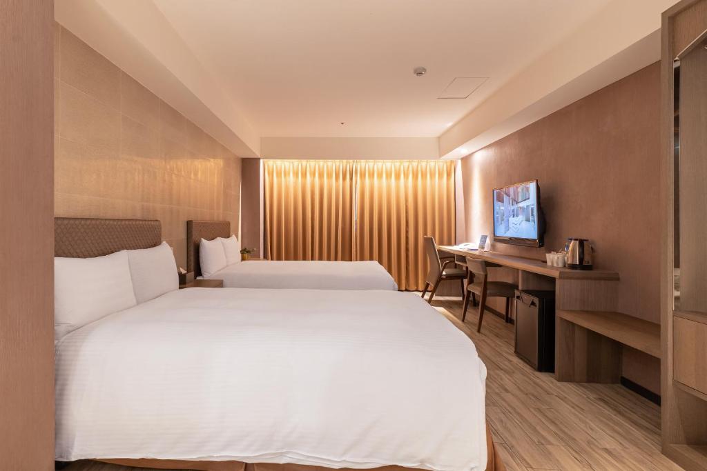 Postel nebo postele na pokoji v ubytování Guide Hotel Taipei Fuxing North