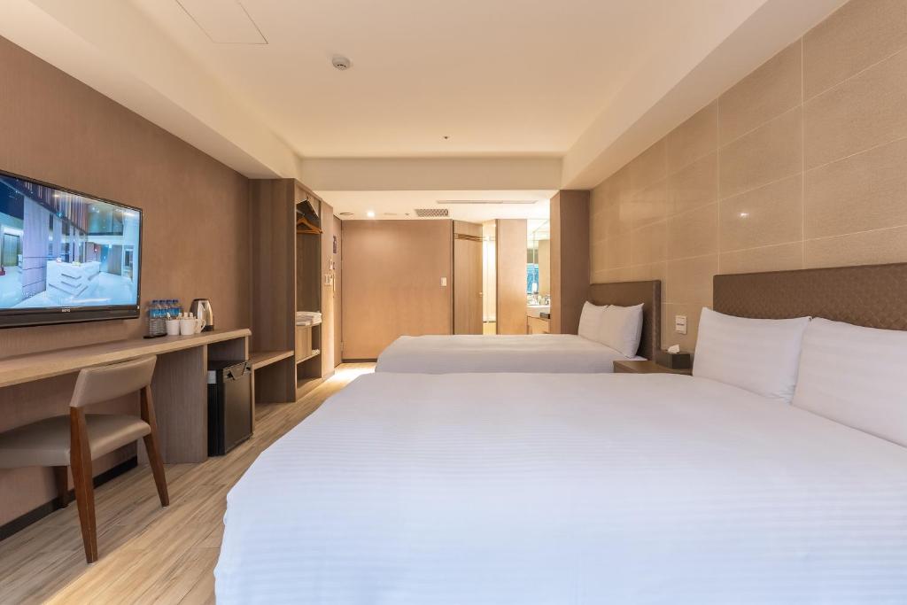 Postel nebo postele na pokoji v ubytování Guide Hotel Taipei Fuxing North