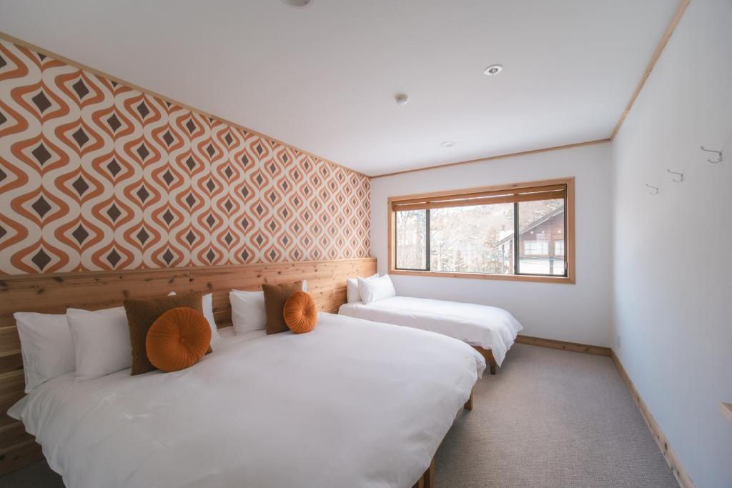 Postel nebo postele na pokoji v ubytování The Brueys Lodge Tangram Madarao