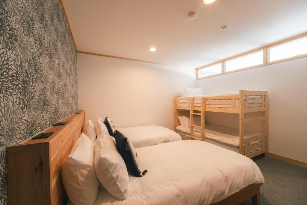 Postel nebo postele na pokoji v ubytování The Brueys Lodge Tangram Madarao