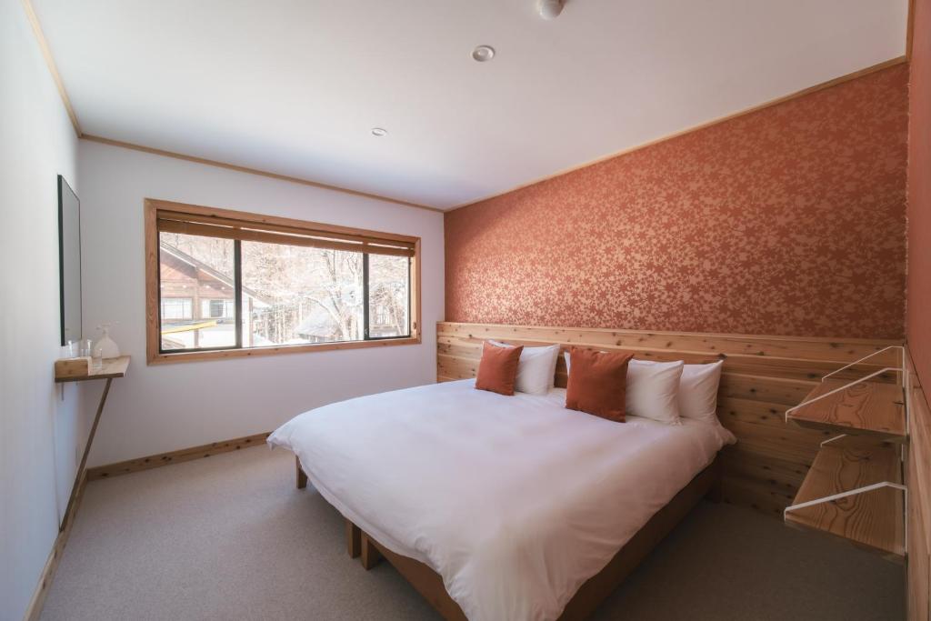 Postel nebo postele na pokoji v ubytování The Brueys Lodge Tangram Madarao