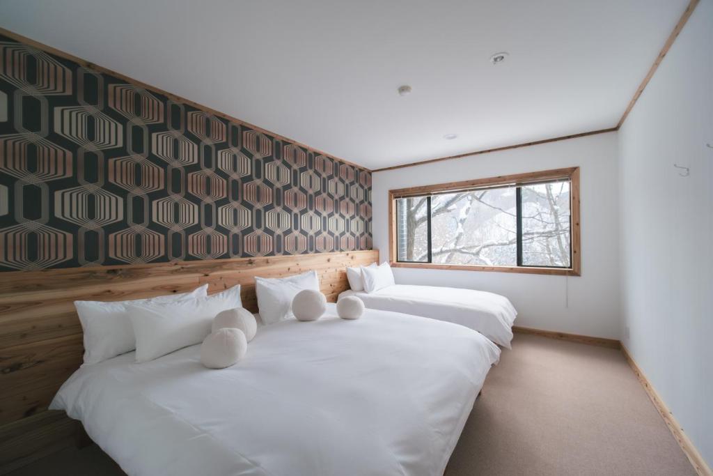 Postel nebo postele na pokoji v ubytování The Brueys Lodge Tangram Madarao