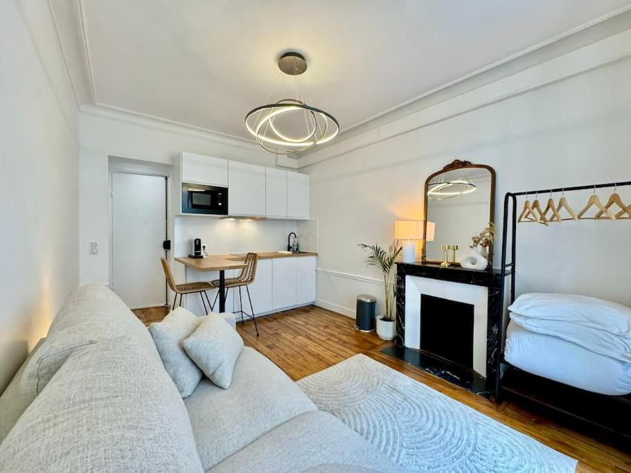 un salon avec un canapé et une cheminée dans l'établissement Nouveau studio central Paris, à Paris