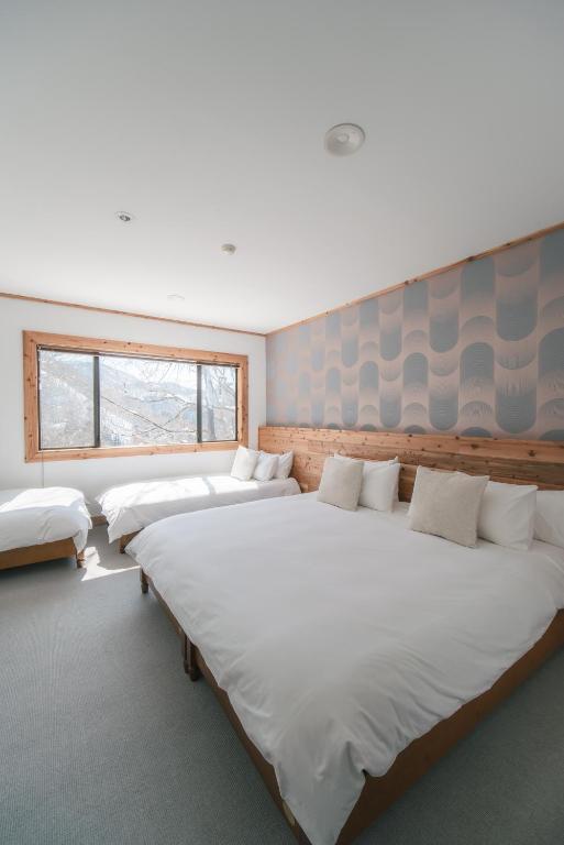 Postel nebo postele na pokoji v ubytování The Brueys Lodge Tangram Madarao