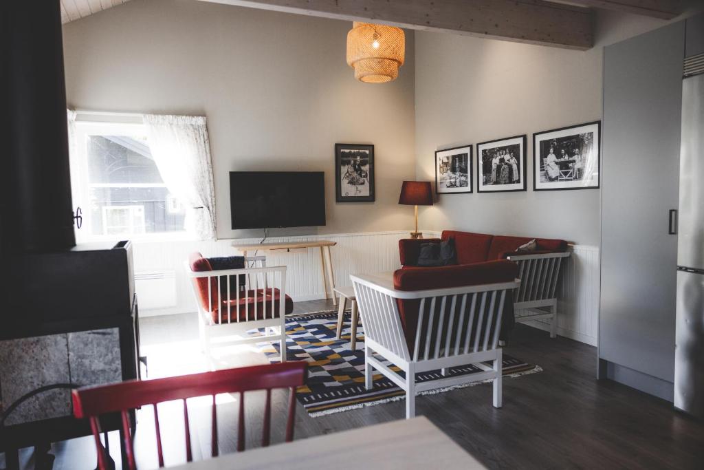 a living room with a couch and a tv at Marholmen Stugby in Norrtälje