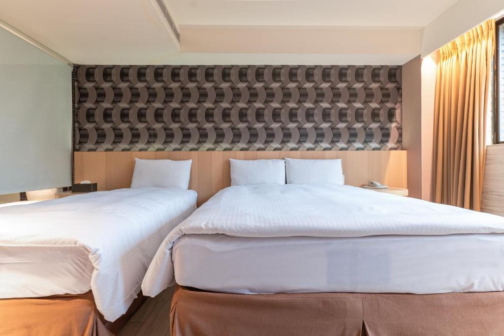 Postel nebo postele na pokoji v ubytování Guide Hotel Taipei Fuxing North