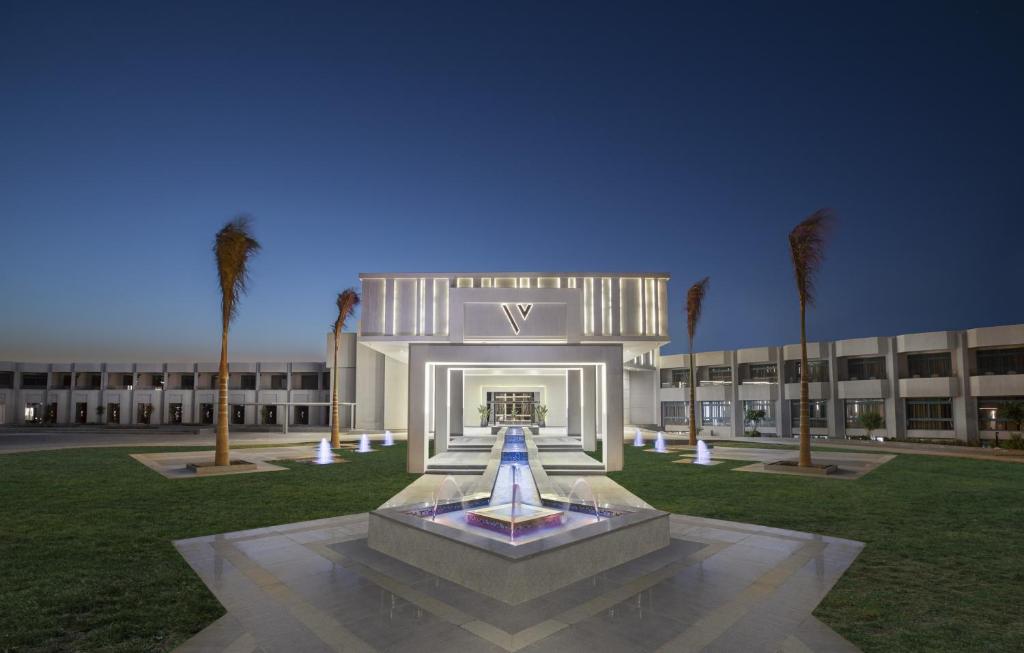 a large building with a fountain in front of it at V Hotel Sharm El Shiekh in Sharm El Sheikh