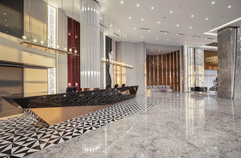 a lobby with a marble floor and a chandelier at V Hotel Sharm El Shiekh in Sharm El Sheikh
