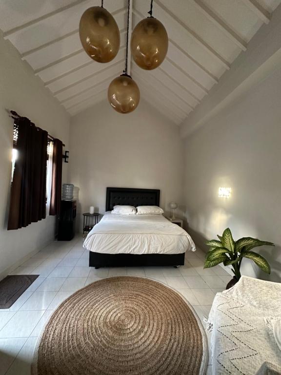 a bedroom with a large bed and a large rug at Pondok Sembilan in Jimbaran