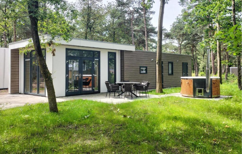 a small cabin with a table and chairs in a yard at Lovely Home In Hellendoorn With Kitchen in Hellendoorn