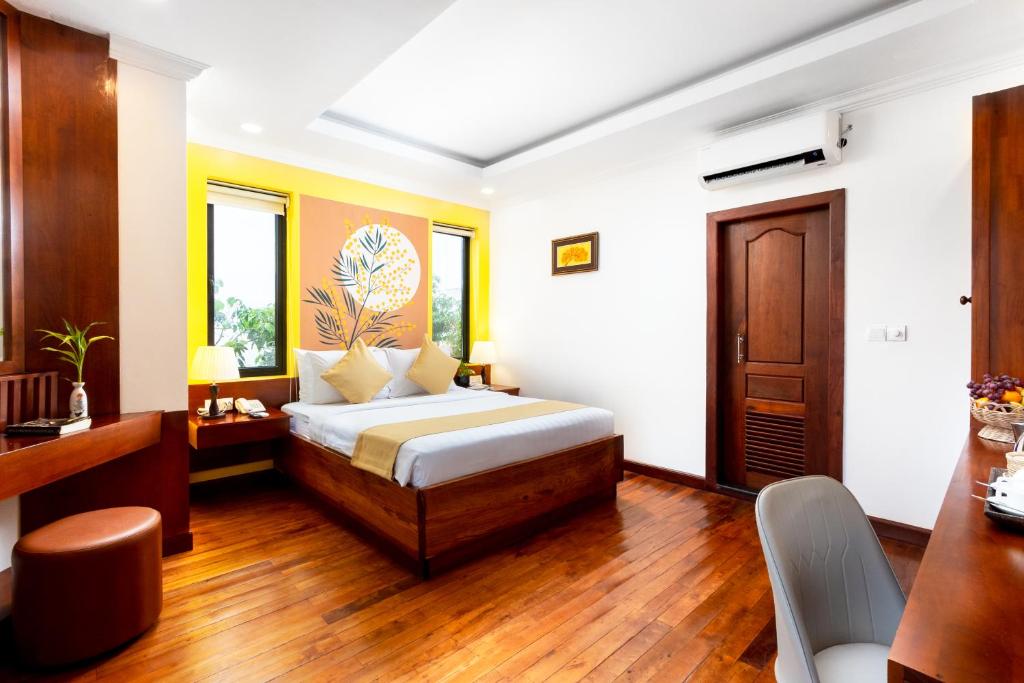 Postel nebo postele na pokoji v ubytování Le Vert Angkor Hotel
