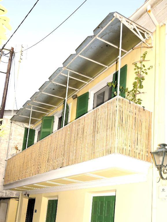 a balcony with a wooden deck on a house at Petrasdream Lefkada in Lefkada