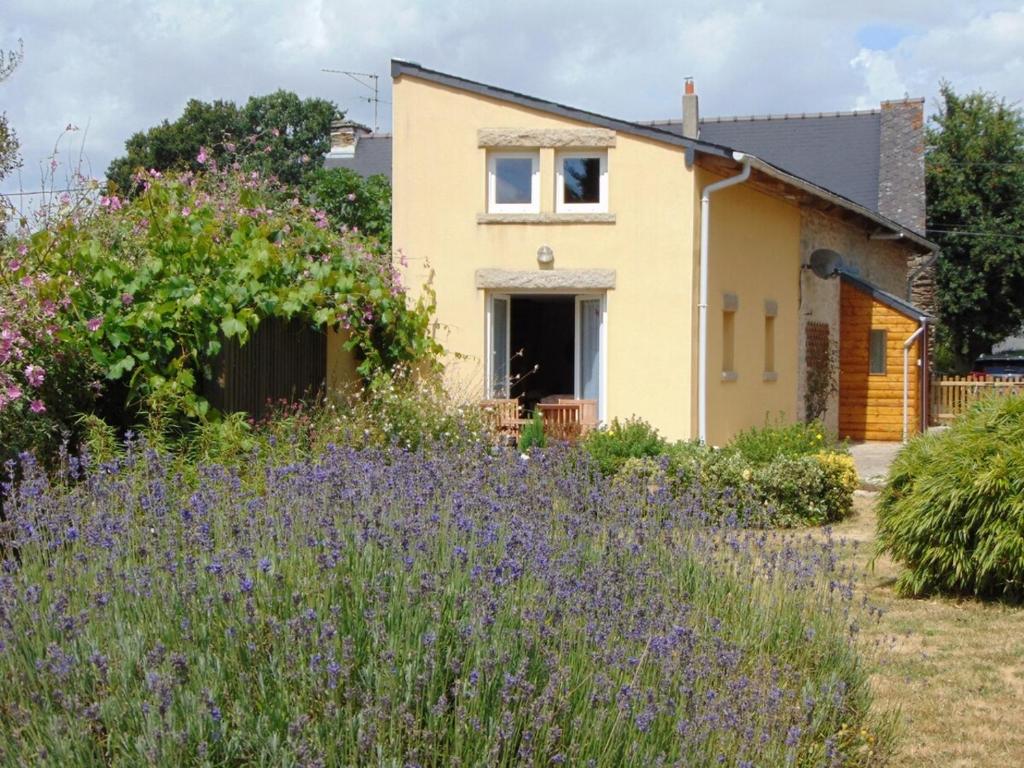 a house with a garden with purple flowers at La Ville Hello, A Spacious House, Sleeps 9, In Rur in Guillac