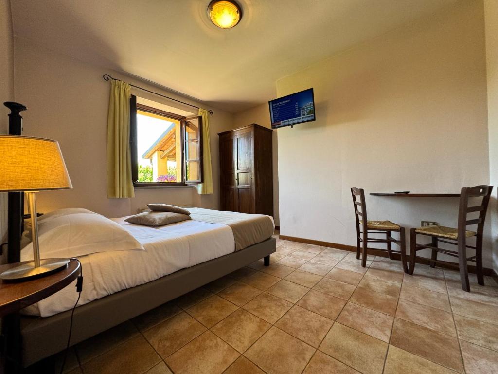 A bed or beds in a room at La Locanda dei Golosi