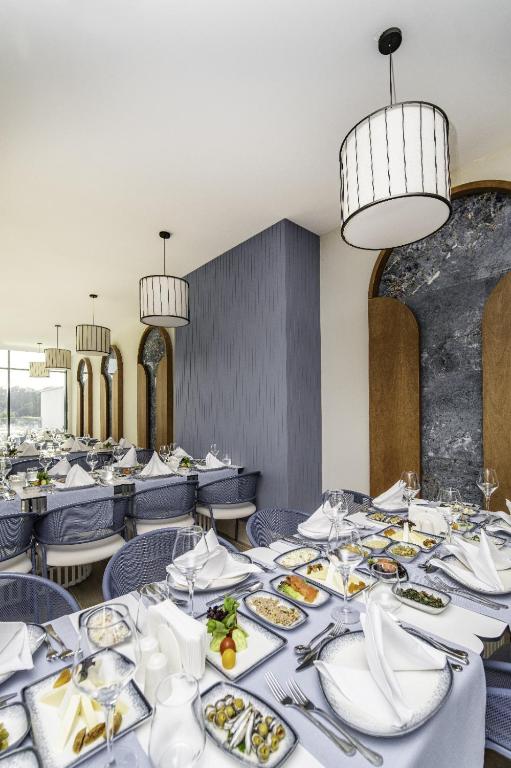 a dining room with tables with plates of food at SIDE MOON PALACE in Side