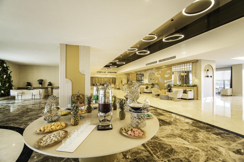 a lobby with a table with food on it at SIDE MOON PALACE in Side