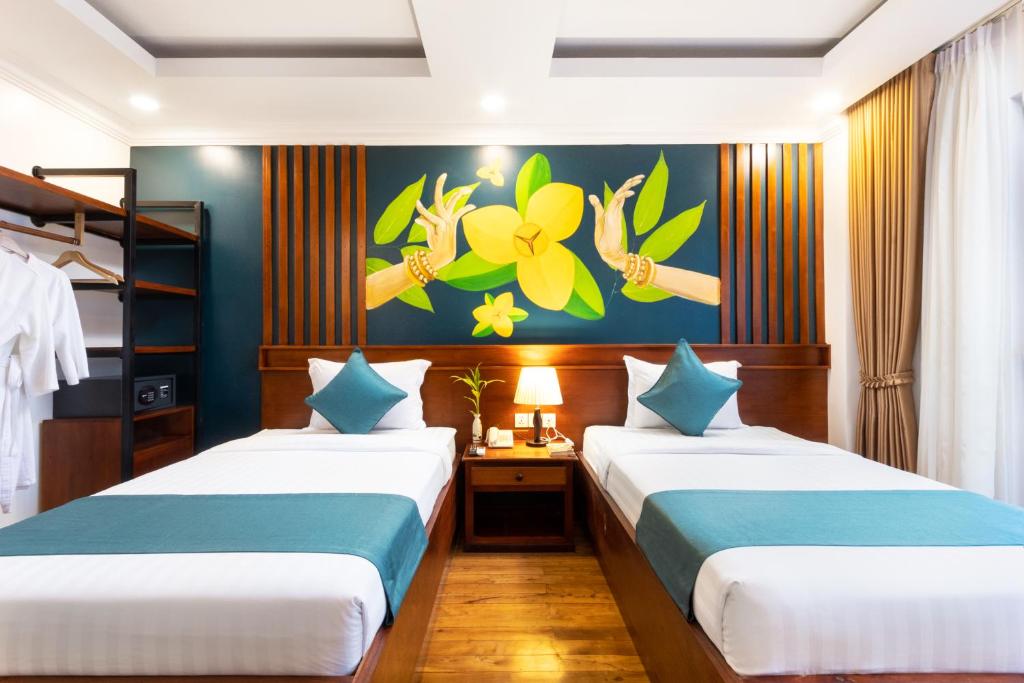 Postel nebo postele na pokoji v ubytování Le Vert Angkor Hotel