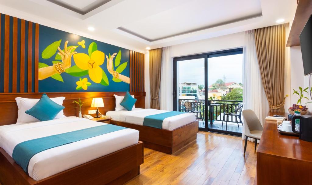 Postel nebo postele na pokoji v ubytování Le Vert Angkor Hotel