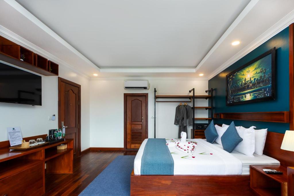 Postel nebo postele na pokoji v ubytování Le Vert Angkor Hotel