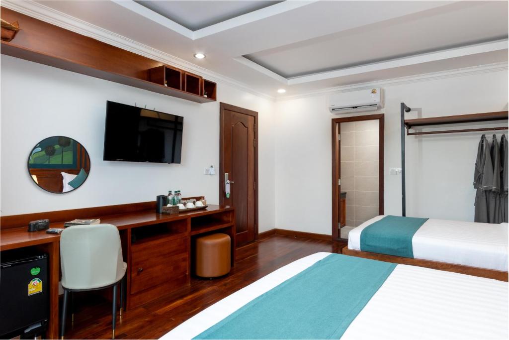 Postel nebo postele na pokoji v ubytování Le Vert Angkor Hotel
