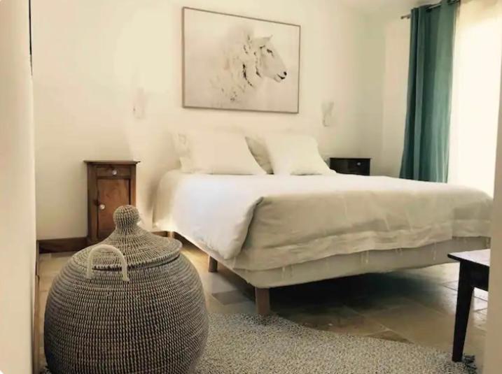 a bedroom with a large bed and a table at Eco logde & spa in Châteaurenard