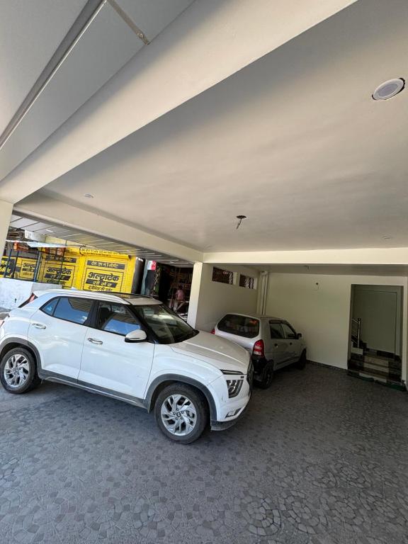 a garage with two cars parked in it at Hotel Kalyani in Nandaprayāg