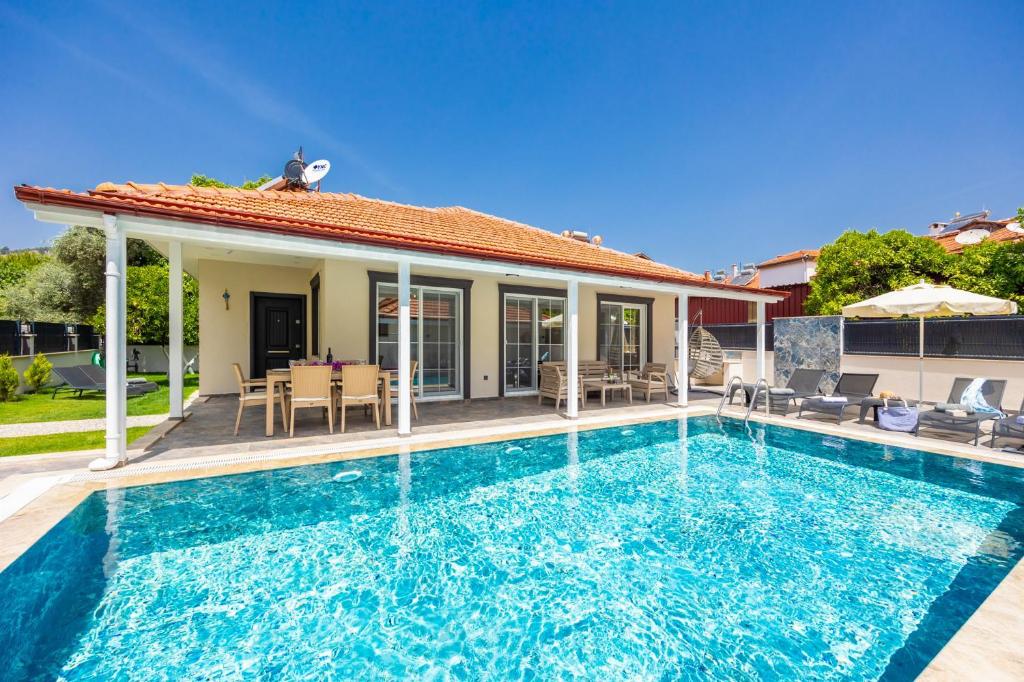 a villa with a swimming pool and a house at Villa Central in Dalyan
