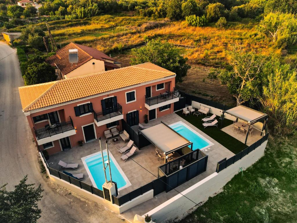 an aerial view of a house with a swimming pool at Corfu Mylos in Ágios Nikólaos