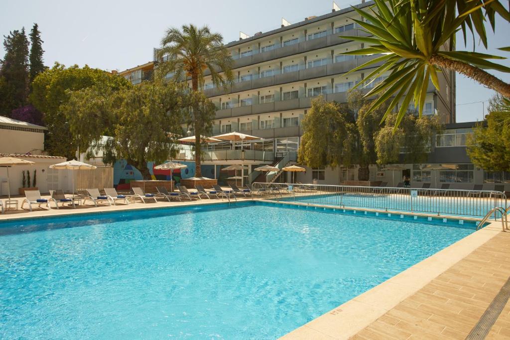 a large swimming pool in front of a hotel at Hotel Joan Miró Museum in Palma de Mallorca