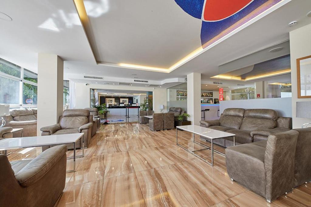 a lobby with couches and tables in a building at Hotel Joan Miró Museum in Palma de Mallorca
