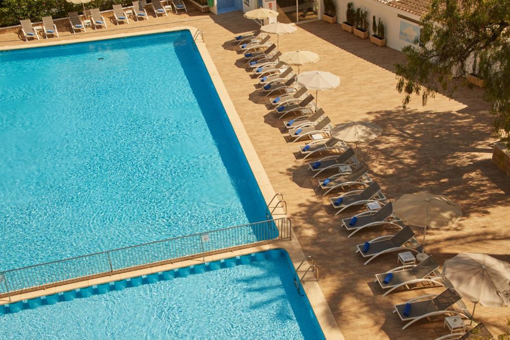 an overhead view of a pool with chairs and umbrellas at Hotel Joan Miró Museum in Palma de Mallorca