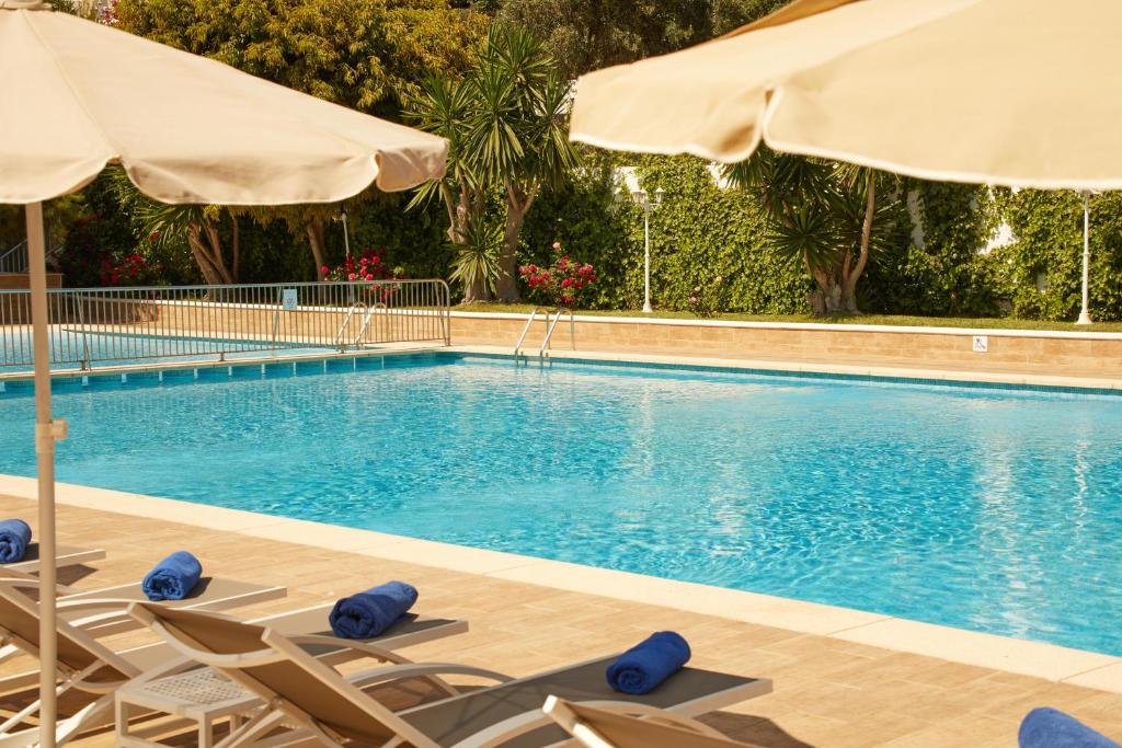 a swimming pool with lounge chairs and an umbrella at Hotel Joan Miró Museum in Palma de Mallorca