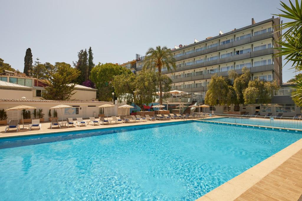 a large swimming pool in front of a hotel at Hotel Joan Miró Museum in Palma de Mallorca
