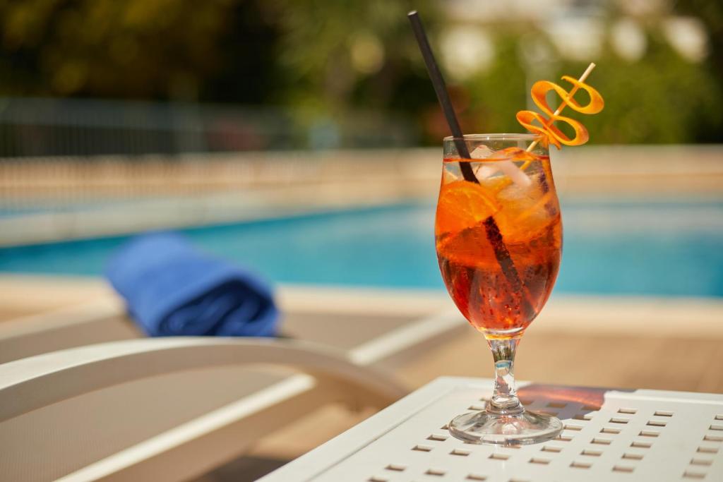 a drink sitting on a table next to a pool at Hotel Joan Miró Museum in Palma de Mallorca