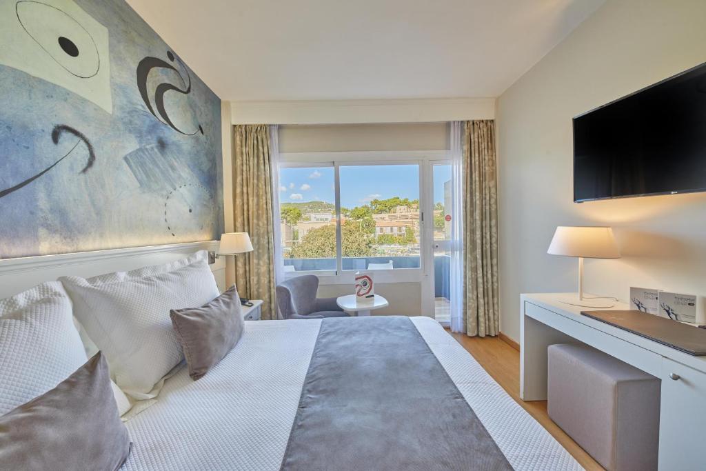 a hotel room with a bed and a television at Hotel Joan Miró Museum in Palma de Mallorca