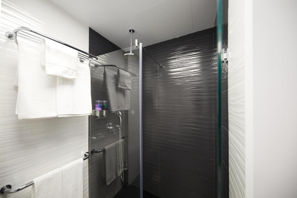 a bathroom with a shower with a glass door at Hotel Joan Miró Museum in Palma de Mallorca