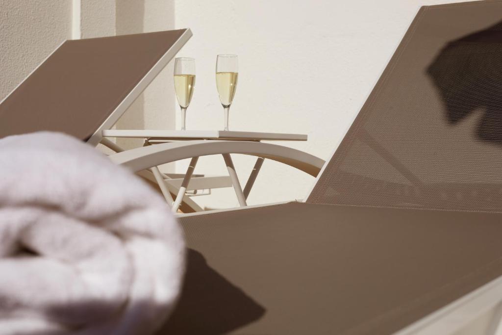 two glasses of champagne on a table with a laptop at Hotel Joan Miró Museum in Palma de Mallorca