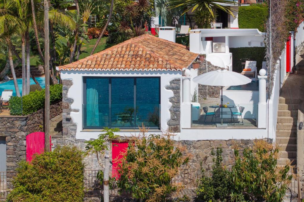 an aerial view of a house with a red door at OurMadeira - Cottage do Mar, secluded in Arco da Calheta