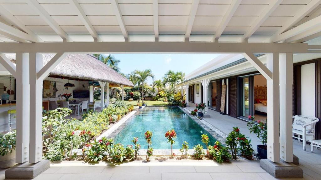 an external view of a house with a swimming pool at Holiday Villa at Pereyère in Grand Baie