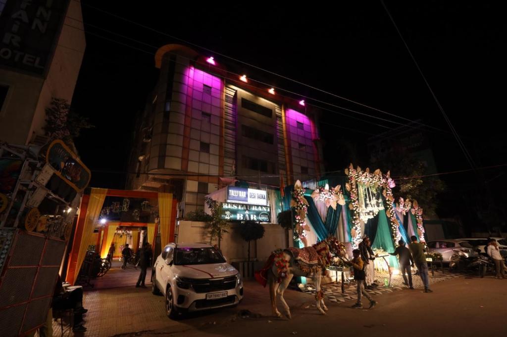 a building with purple lights on the side of it at Hotel Gagan Suite in Kānpur